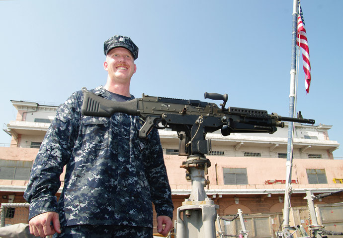 A US naval officer displays an automatic weapon mounted on the USS Taylor in Odessa on July 14, 2010 during the US-Ukraine joint maritime exercises "Sea Breeze 2010". (AFP Photo / Alexey Kravtsov)