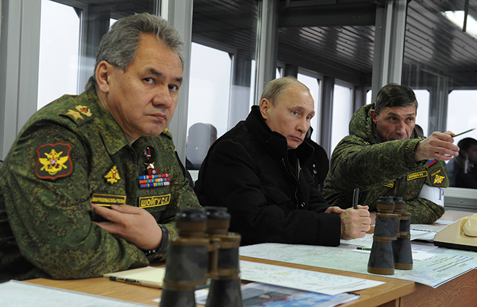 March 3, 2014. Russian President Vladimir Putin supervises the military exercises at the Kirillovsky test range in Leningrad Region. Left: Russian Defence Minister Sergey Shoigu, right: Chief of the Russian Army's Main Department of Combat Preparation Ivan Buvaltsev. (RIA Novosti / Michael Klimentyev)