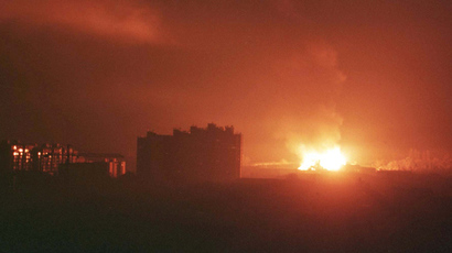 An explosion followed by a huge fire rages in the south-west part of Pristina in the early hours March 25, 1999 after NATO forces launched a missile attack against Yugoslavia (Reuters / Yannis Behrakis)