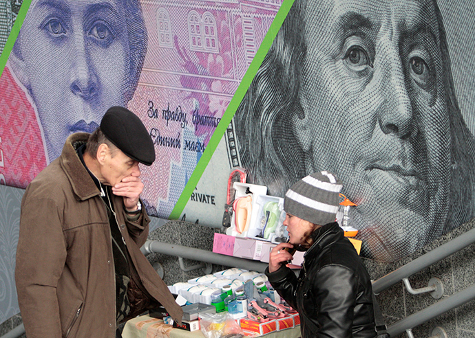 A customer and street vendor are seen before the background of an outdoor ad with an image of the Ukrainian hryvnia and U.S. dollar bank notes in central Kiev (Reuters / Anatolii Stepanov)