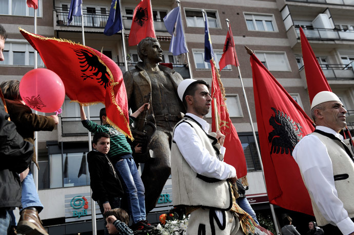 Kosovars hold Albanian flags as they take part in celebrations marking the 6th anniversary of Kosovo's declaration of independence from Serbia, in Pristina on February 17, 2014. (AFP Photo / Armend Nimani)