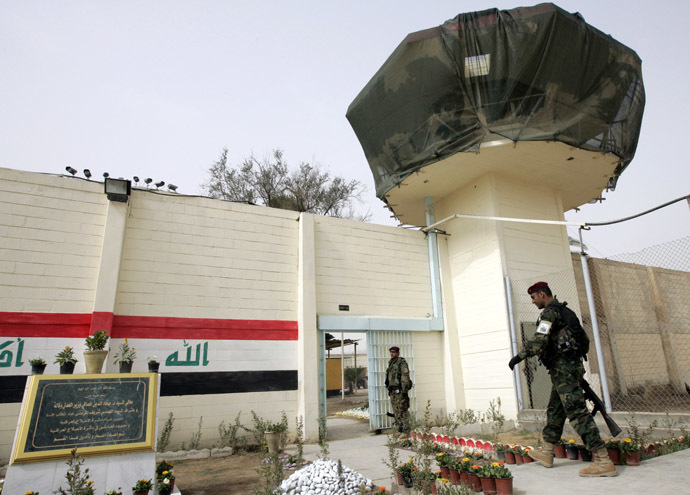 An Iraqi soldier walks near a watch tower of the Baghdad Central Prison in Baghdad's Abu Ghraib (Reuters)