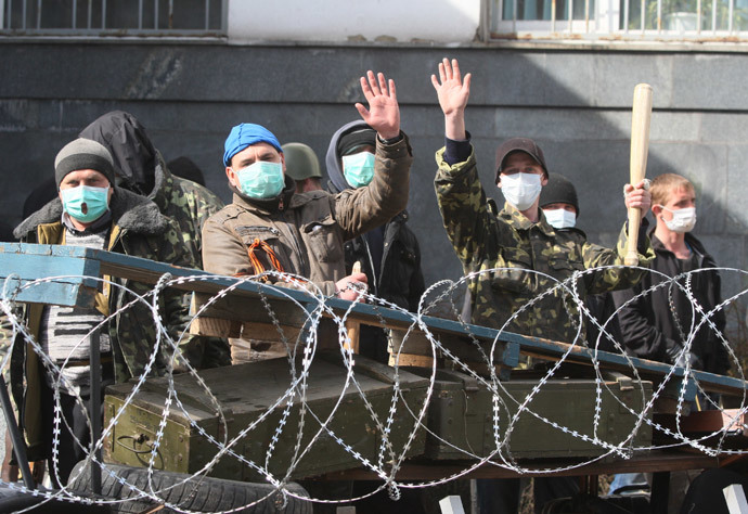 Pro-Russian activists guard a barricade set at the Ukrainian regional Security Service building on the eastern city of Donetsk on April 7, 2014.(AFP Photo / Alexander Khudoteply)