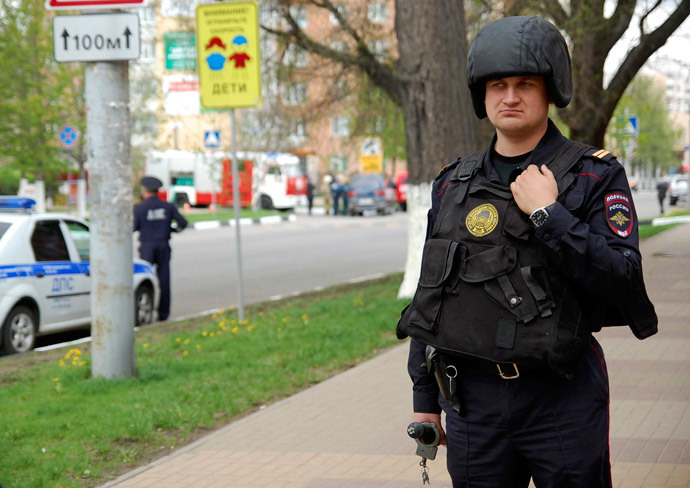 An Interior Ministry member stands guard as he blocks the way near an office of Zapadny bank in Belgorod April 21, 2014.(Reuters / Vladimir Kornev)