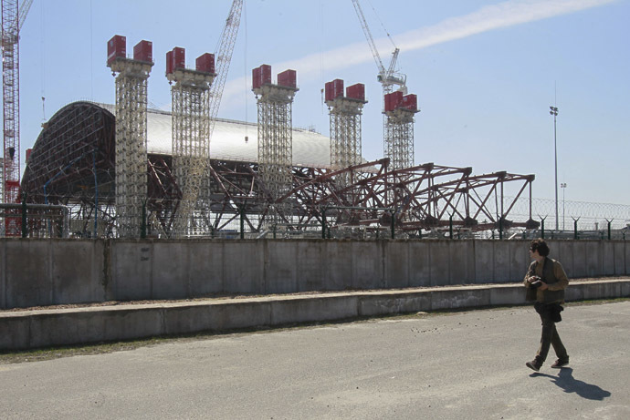 A man looks at the New Safe Confinement (NSC) structure at the Chernobyl Nuclear Power Plant April 23, 2013. (Reuters/Gleb Garanich)