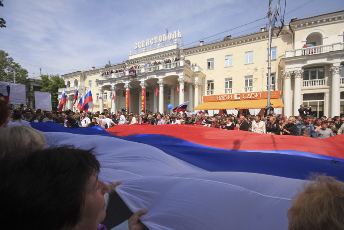 People hold a giant Russian flag during celebrations to mark Victory Day in the Crimean port of Sevastopol May 9, 2014. (Reuters)