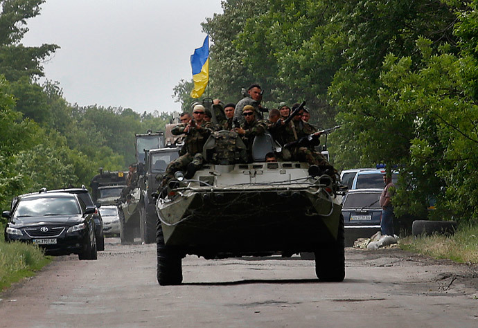 Ukrainian soldiers ride atop an armored personnel carrier, south of Donetsk (Reuters / Yannis Behrakis)