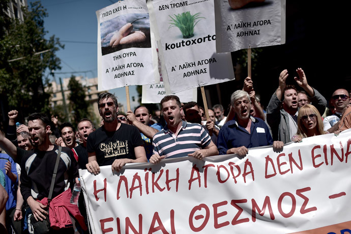 Farmers' market producers and vendors of the common open air markets prevalent across Greece shout slogans as they protest against liberal reforms in central Athens on May 2, 2014. (AFP Photo / Aris Messinis)