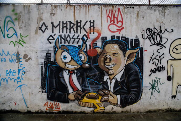 A graffiti depictingTatubola (L), the mascot of the upcoming FIFA World Cup, Tatubola, can be seen on a wall of the Maracana metro station, the nearest one to the Maracana stadium, during the restoration works ahead of the upcoming FIFA World Cup in Rio de Janeiro, Brazil, on May 28, 2014. (AFP Photo / Yasuyoshi Chiba)