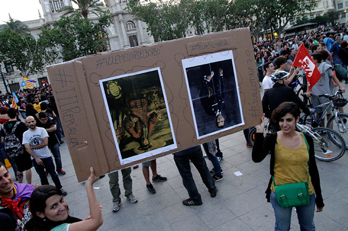 Protesters hold a placard with up-side-down portraits of Spain's first Bourbon King Felipe V (L) and Crown Prince Felipe during an anti-royalist demonstration at the town hall square in Valencia, June 2, 2014. (Reuters / Heino Kalis)