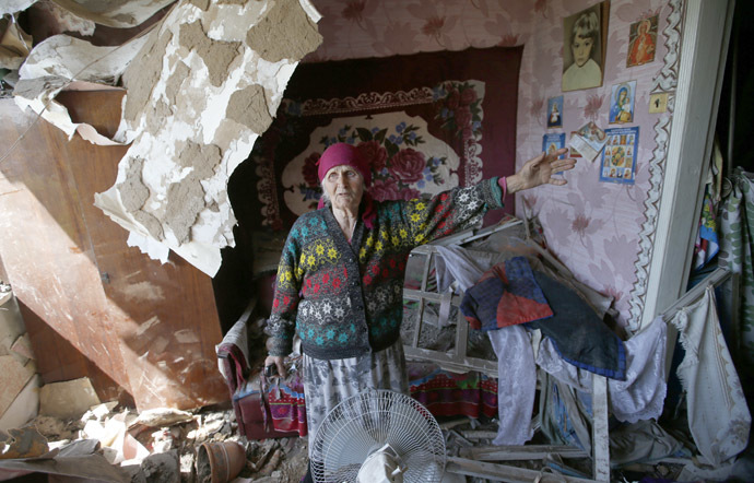 Zinaida Patskan, 80, speaks as she stands inside her home which was destroyed by Ukrainian artillery, on the outskirts of the eastern Ukrainian town of Slaviansk May 22, 2014. (Reuters/Maxim Zmeyev)