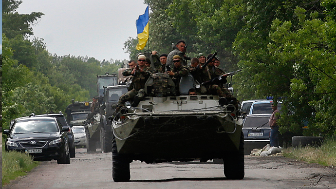 Ukrainian soldiers ride atop an Armored Personnel Carrier (APC) in eastern Ukrainian town of Volnovakha, south of Donetsk (Reuters / Yannis Behrakis)