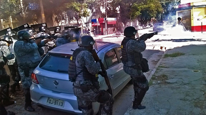 Riot policemen fire tear gas during an anti-World Cup protest on the morning the Brazilian mega-city hosts the tournament's opening match, in Sao Paulo on June 12, 2014. (AFP Photo / Laurent Thomet)