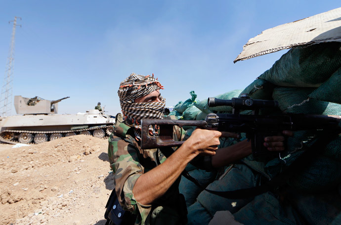 Iraqi Kurdish forces take position near Taza Khormato as they fight jihadist militants from the Islamic State of Iraq and the Levant (ISIL) positioned five kilometers away in Bashir, 20 kms south of Kirkuk, on June 23, 2014. (AFP Photo / Karim Sanib)