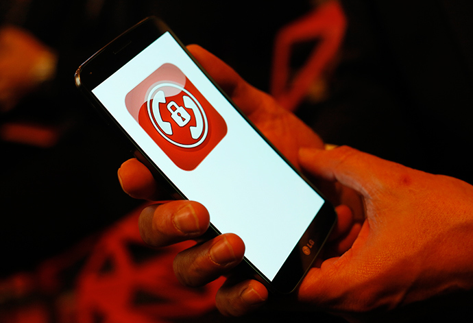Hans-Christoph Quelle, managing director of Secusmart displays a new "Secure Call" smartphone at the booth of Vodafone at the CeBit computer fair in Hanover (Reuters / Wolfgang Rattay)