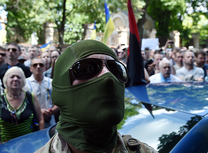A masked man, soldier of the volunteer Ukrainian army "Donbass" battalion, takes part in a rally by Maidan activists at Independence Square in Kiev on June 29, 2014. (AFP Photo / Sergei Supinsky)