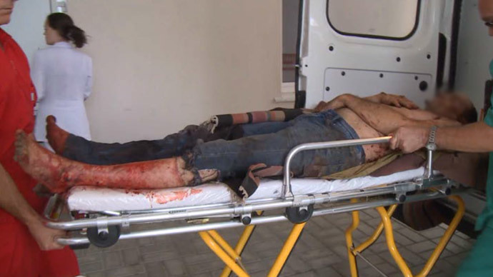 Screenshot from RT video / A man taken to hospital after he was wounded in shelling by Kievâs troops in Lugansk, Eastern Ukraine
