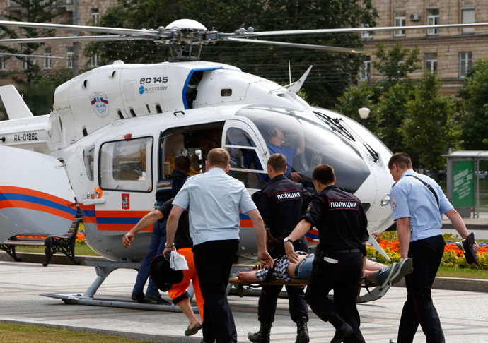 Members of the emergency services carry an injured passenger outside a metro station following an accident on the subway in Moscow July 15, 2014. (Reuters / Sergei Karpukhin)