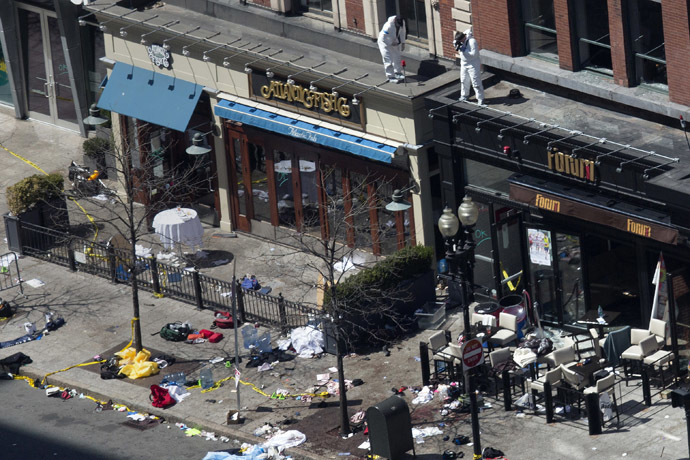 Officials take crime scene photos a day after two explosions hit the Boston Marathon in Boston, Massachusetts April 16, 2013. (Reuters/Shannon Stapleton)