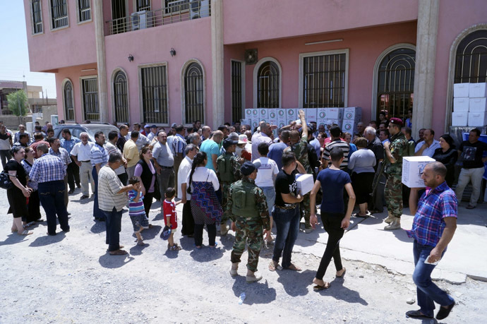Displaced Christians wait for humanitarian aid at a church in Hamdaniya town, east of Mosul, northwest of Baghdad, July 20, 2014. (Reuters/Stringer)