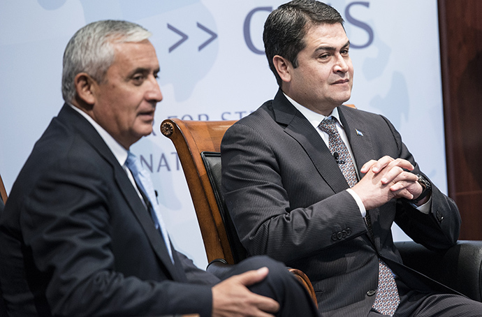 President of Guatemala Otto Perez Molina (L) and President of Honduras Juan Orlando Hernandez wait to speak during an event at the Center for Strategic and International Studies July 24, 2014 in Washington, DC. (AFP Photo / Brendan Smialowski)