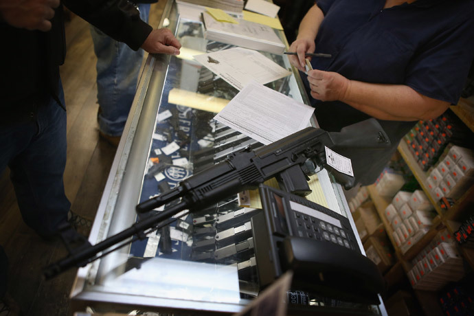 A customer purchases an AK-47 style rifle for about $1200 at Freddie Bear Sports sporting goods store in Tinley Park, Illinois. (Scott Olson / Getty Images / AFP)