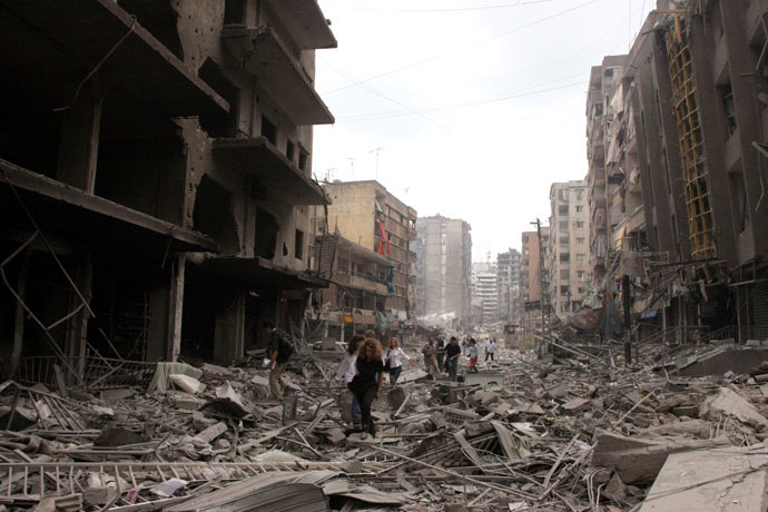 Journalist inspect the damaged buildings after Israeli air raids in southern Beirut July 20 2006. (Reuters)
