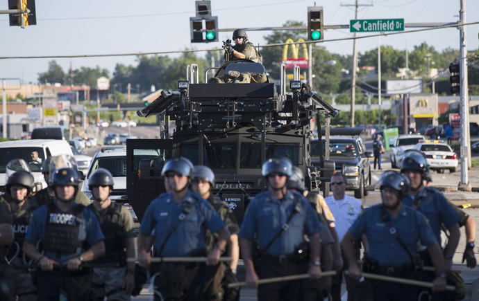 Riot police stand guard as demonstrators protest the shooting death of teenager Michael Brown in Ferguson, Missouri August 13, 2014. (Reuters / Mario Anzuoni)