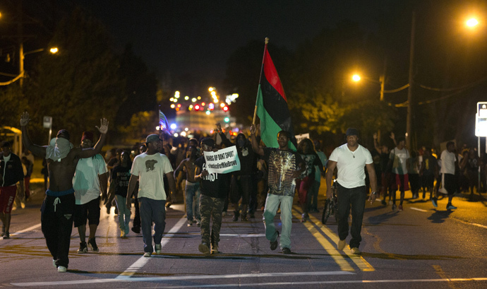 Demonstrators march in the street while protesting the shooting death of black teenager Michael Brown in Ferguson, Missouri August 12, 2014. (Reuters / Mario Anzuoni) 