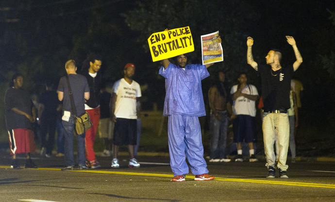 Demonstrators stand in the street in Ferguson, Missouri August 11, 2014. (Reuters / Mario Anzuoni)