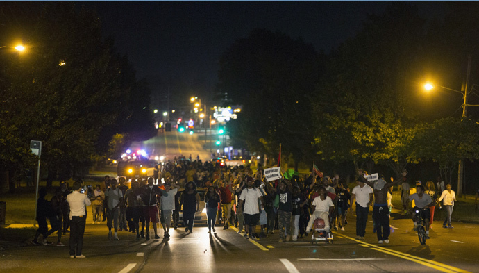 Demonstrators march in the street while protesting the shooting death of black teenager Michael Brown in Ferguson, Missouri August 12, 2014. (Reuters / Mario Anzuoni)