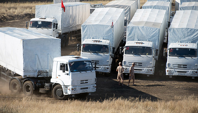 Lorries part of a Russian humanitarian convoy leave their parking for the "Donetsk" checkpoint at the Ukrainian border some 30 km outside the town of Kamensk-Shakhtinsky in the Rostov region, on August 17, 2014. (AFP Photo / Dmitry Serebryakov)