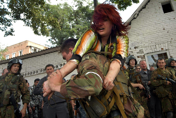 A Russian special forces soldier carries an injured woman during the rescue operation of Beslan's school, northern Ossetia, 03 September 2004. (AFP Photo/Yuri Tutov)