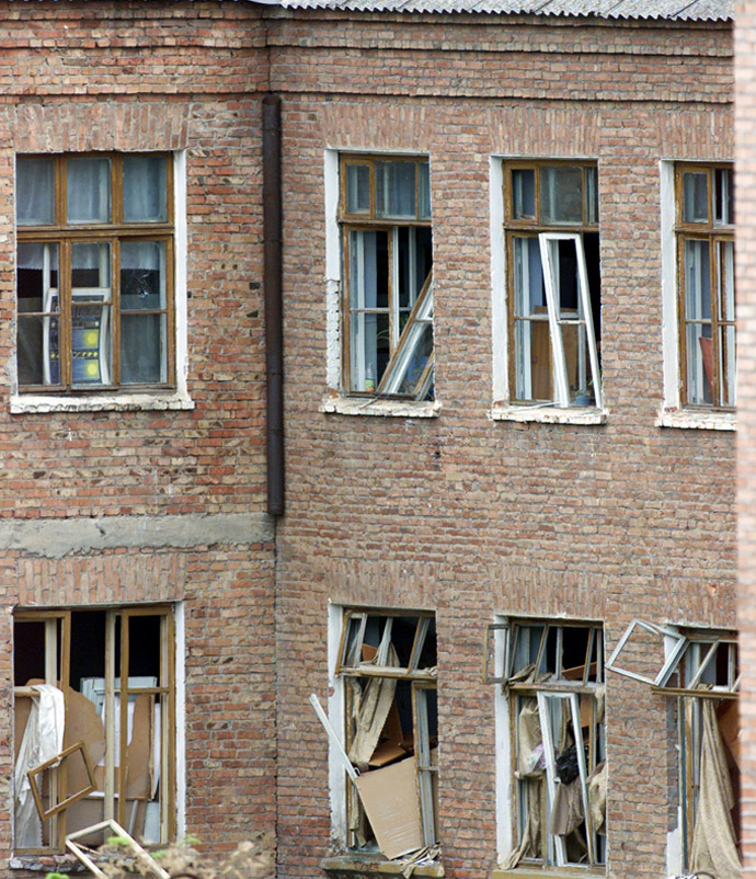 Broken windows are seen at the rear of a school building seized by heavily armed masked men and women in the town of Beslan in the province of North Ossetia. Broken windows are seen at the rear of a school building seized by heavily armed masked men and women in the town of Beslan in the province of North Ossetia near Chechnya, September 2, 2004. (Reuters)