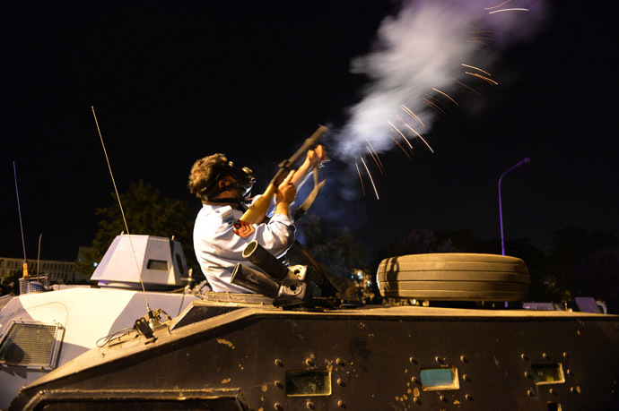 A Pakistani policeman fires tear gas shell toward the opposition protesters near the prime minister's residence following clashes with security forces in Islamabad on August 31, 2014. (AFP Photo)