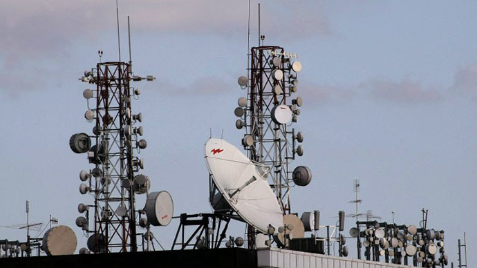 Satellite dishes and cell phone towers atop a roof of a building (AFP Photo / Thomas Coex)