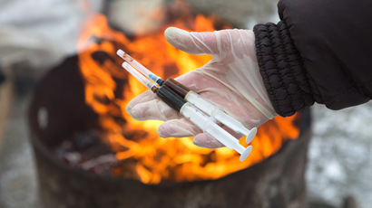 A Federal Service for Drug Control employee destroys syringes with dexamethasone in the forest near Nizhny Novgorod. (RIA Novosti/Oleg Zoloto)