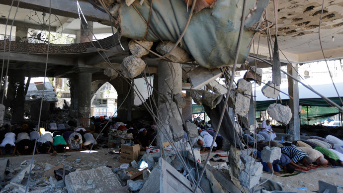 Palestinian Muslim worshipers attend Friday noon prayer amidst the rubble of the al-Susi mosque in Gaza City.(AFP Photo / Mohammed Abed )