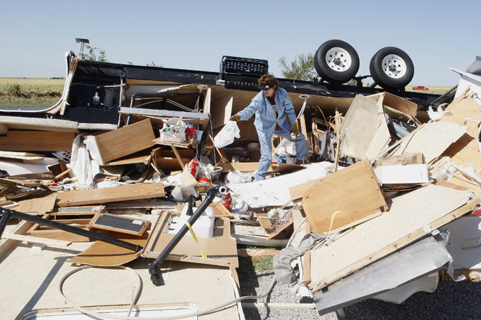 Mikie Hooper of Tuttle, Oklahoma, collects her belongings from her RV which was destroyed by a tornado in El Reno, Oklahoma, June 1, 2013. (Reuters/Bill Waugh)