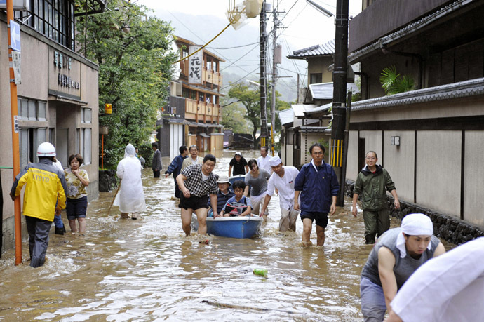 Guests at a Japanese inn are rescued by boat along a flooded road after tropical storm Man-yi, locally named Typhoon No.18, made landfall in Kyoto, western Japan, in this photo taken by Kyodo September 16, 2013. (Reuters/Kyodo)
