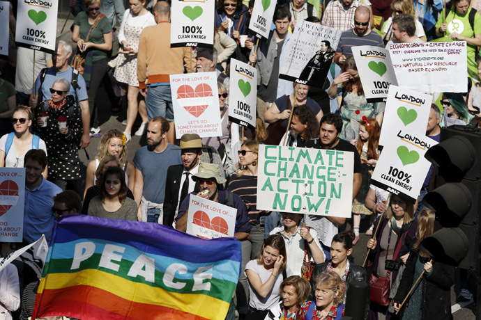 Demonstrators display placards and banners as they participate in the Peoples Climate March in London on September 21, 2014. (AFP Photo/Adrian Dennis)