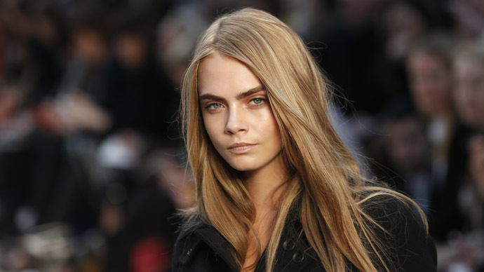Model Cara Delevingne presents a creation from the Burberry Prorsum Autumn/Winter 2013 collection during London Fashion Week February 18, 2013. (Reuters/Suzanne Plunkett)