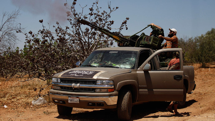 Islamist Syrian rebel group Jabhat al-Nusra members fire their weapon towards what activists said were warplanes loyal to Syria's president Bashar Al-Assad on Al-Khazan frontline of Khan Sheikhoun, northern Idlib province May 17, 2014. (Reuters / Hamid Khatib)