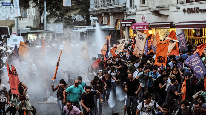 Turkish police use water cannon as they clash with leftist protestors on August 28, 2014, in Istanbul. Leftist groups gathered to protest against new Turkish president Recep Tayyip Erdogan at Istiklal avenue in Istanbul.(AFP Photo / Ozan Kose)