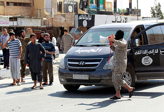 An Islamic State militant uses a loud-hailer to announce to residents of Tabqa city that Tabqa air base has fallen to Islamic State militants, in nearby Raqqa city (Reuters / Stringer)