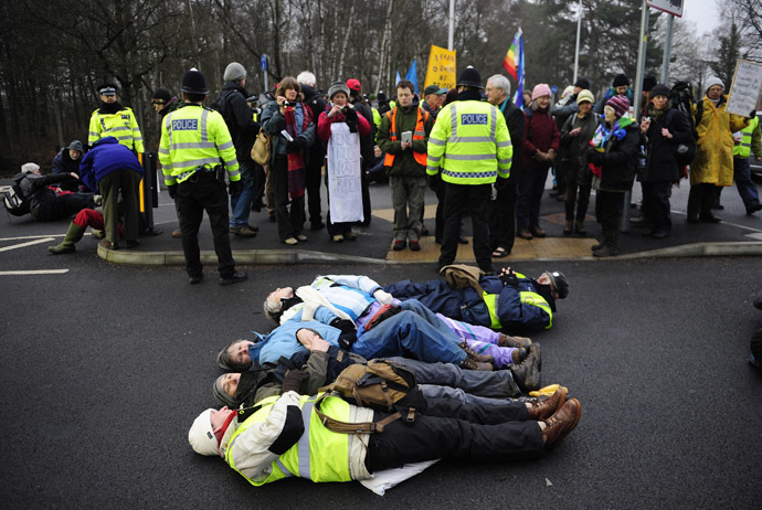 Anti-nuclear demonstrators lie in the road outside a gate of the Atomic Weapons establishment (AWE) at Aldermaston in southern England February 15, 2010. (Reuters/Kieran Doherty)
