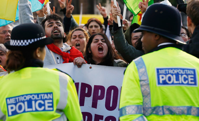 Kurdish demonstrators and supporters protest outside the Houses of Parliament in London October 8, 2014. (Reuters / Luke MacGregor)