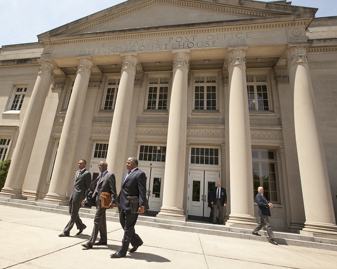 Former Charlotte, North Carolina Mayor Patrick Cannon (L) walks out of federal court after he pleaded guilty to corruption charges in June. (Reuters/Jason Miczek)