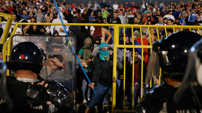 Fans of Serbia face the riot police during the Euro 2016 Group I qualifying soccer match between Serbia and Albania at the FK Partizan stadium in Belgrade October 14, 2014.(Reuters / Marko Djurica)