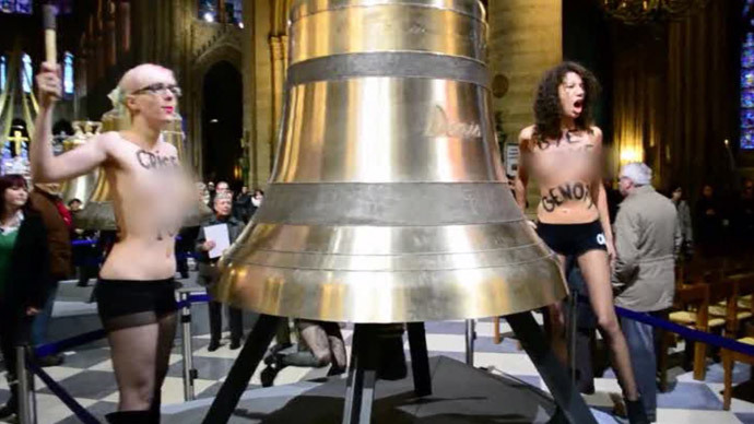 Femen strike bells and shout âPope no more!â and âClear off, homophobe!â. February, 2013. (Screenshot from RT report)
